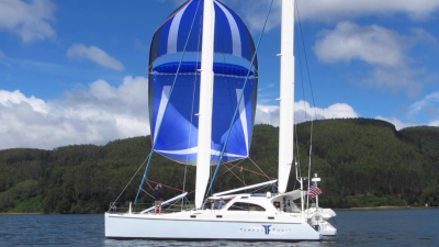 catamaran under sail with parasailer and mastfoils